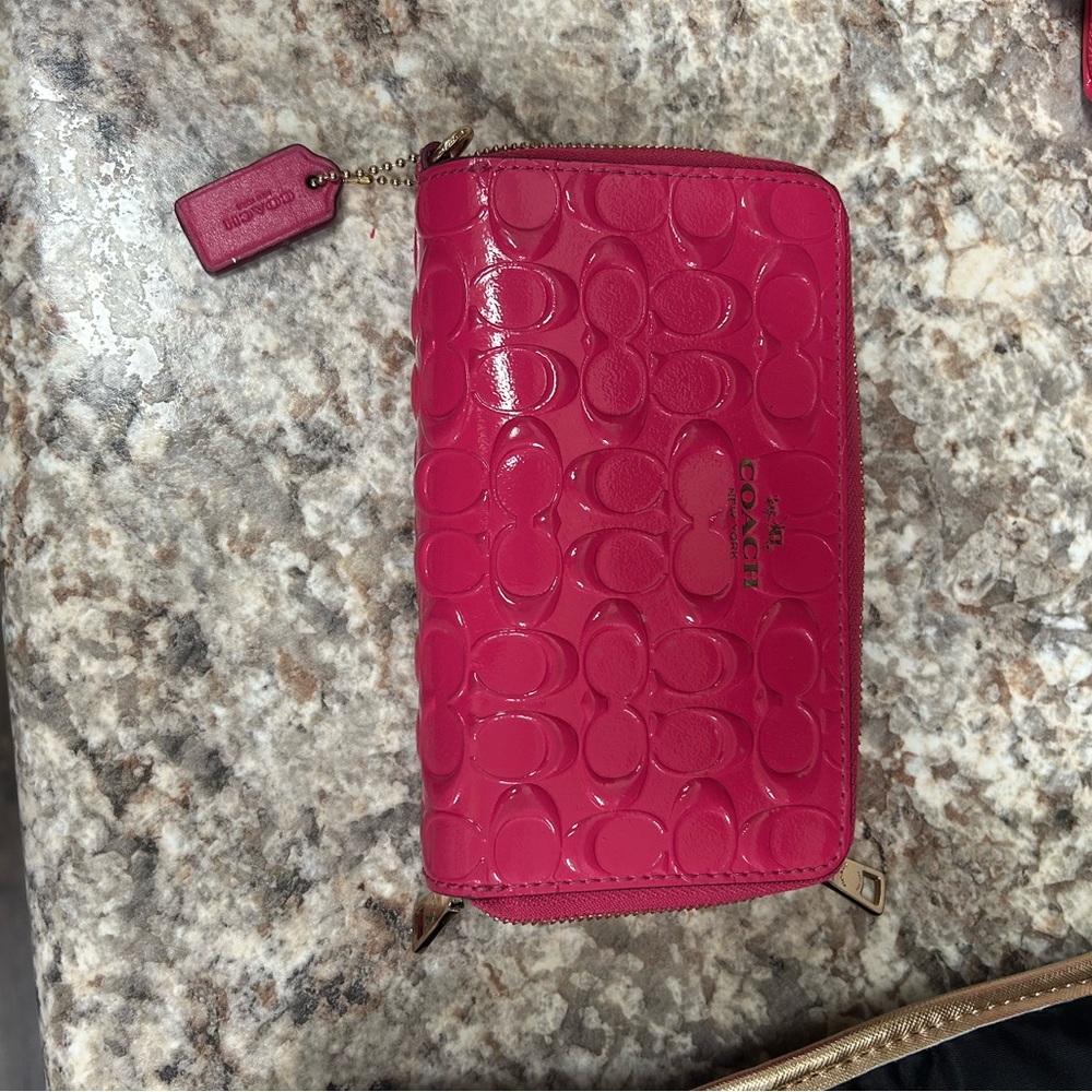 Embossed Medium zip around Coach wallet- Magenta color.